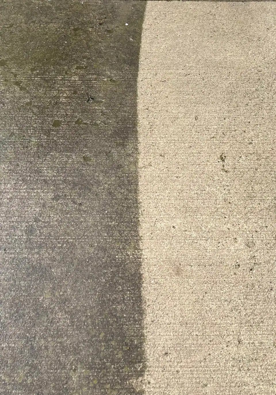 A freshly pressure-washed concrete driveway