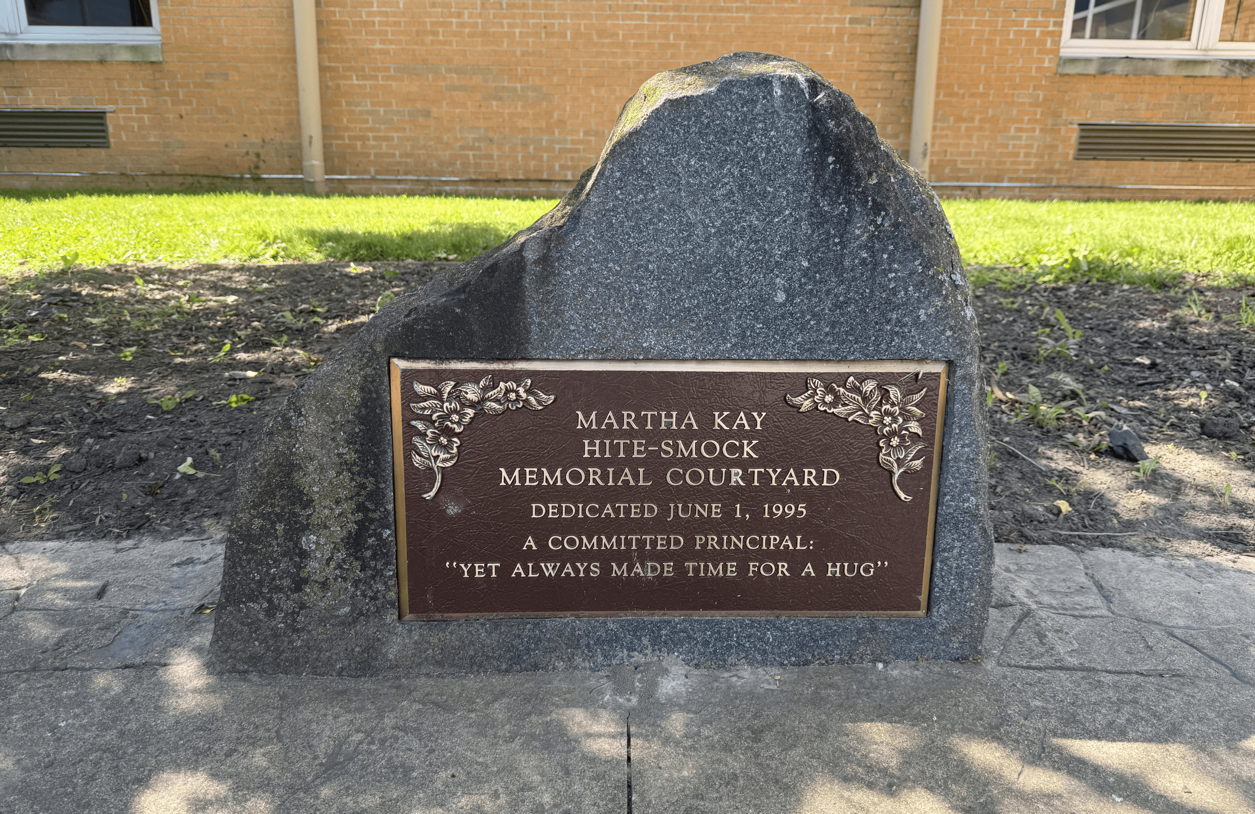 The Martha Kay Hite-Smock memorial monument and plaque before cleaning, dulled by dirt and moss
